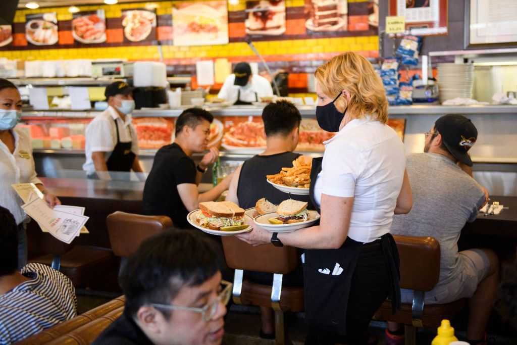 Waitress serves food.