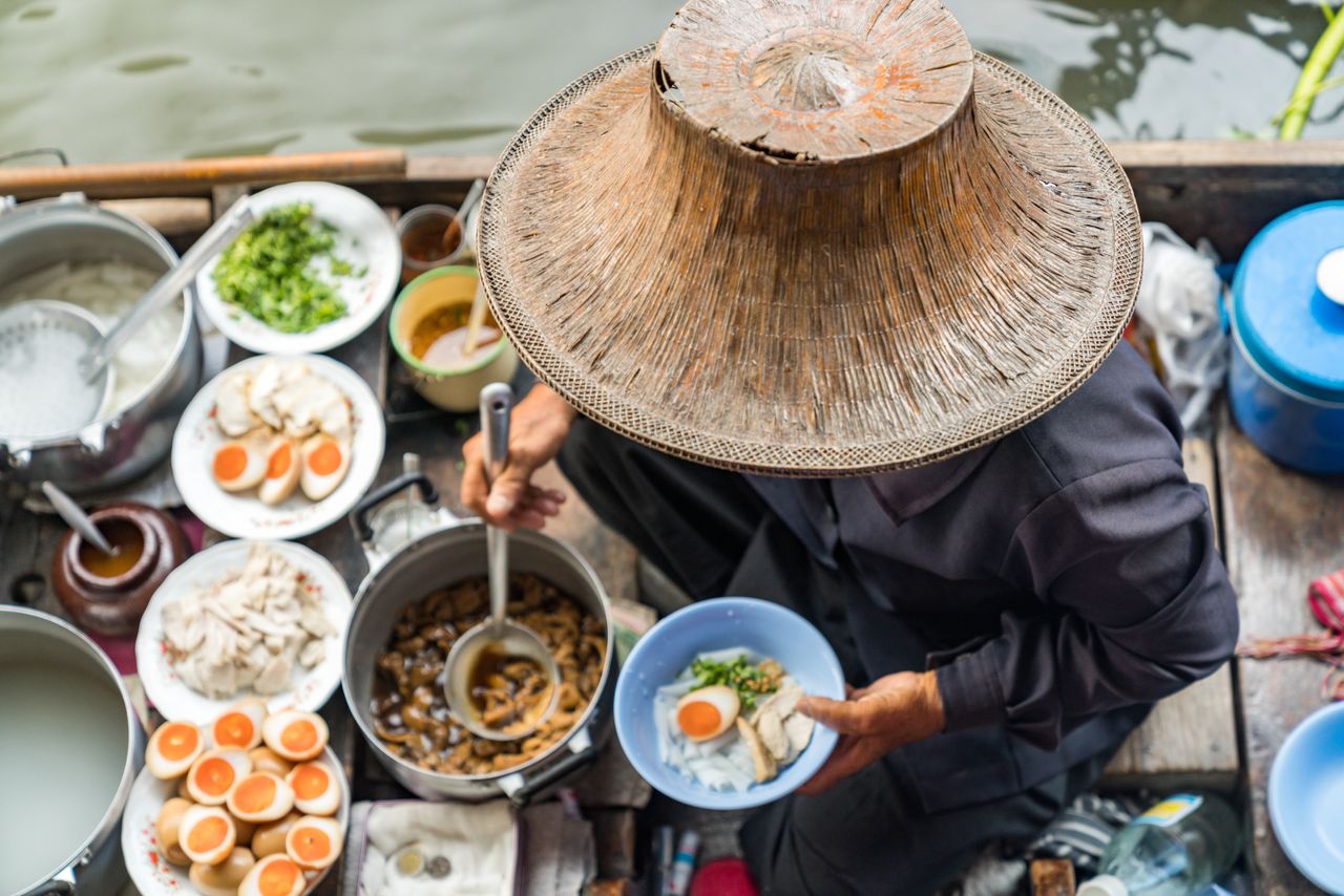 Thai noodle soup bar on floating canoe