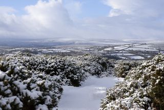 A photograph of Dartmoor landscape in the snow.