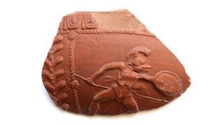 A pottery fragment depicting a gladiator with a spear