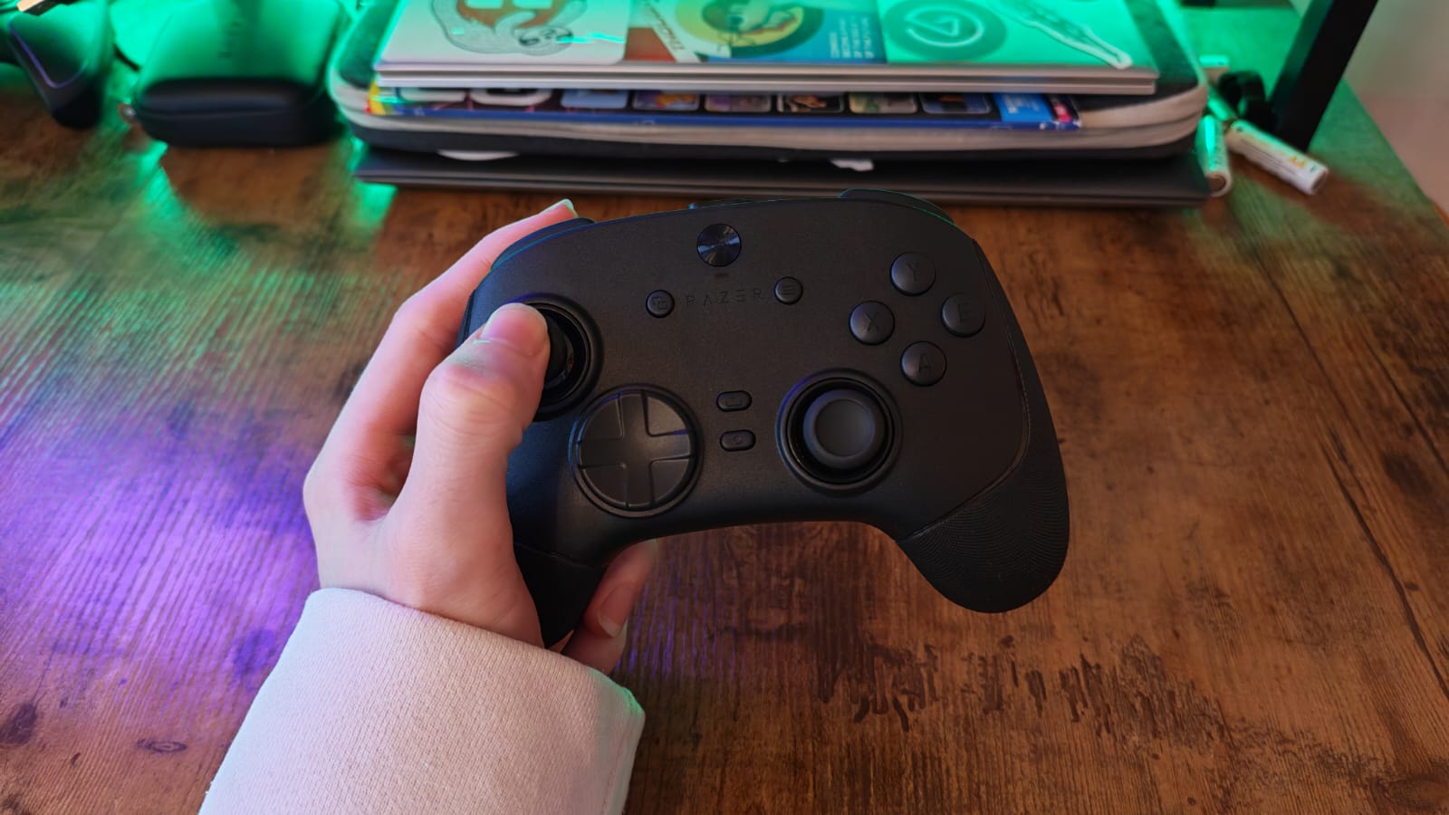 The Razer Wolverine V3 Pro 8K in the hand of a reviewer