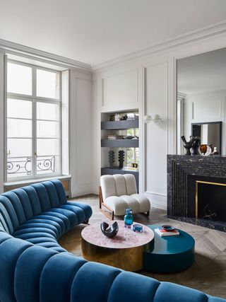 a white living room with a navy blue sofa
