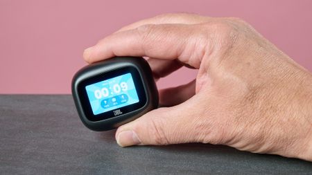 Man holding the JBL Live Beam 4 smart charging case