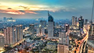City skyline image of Jakarta at sunset.