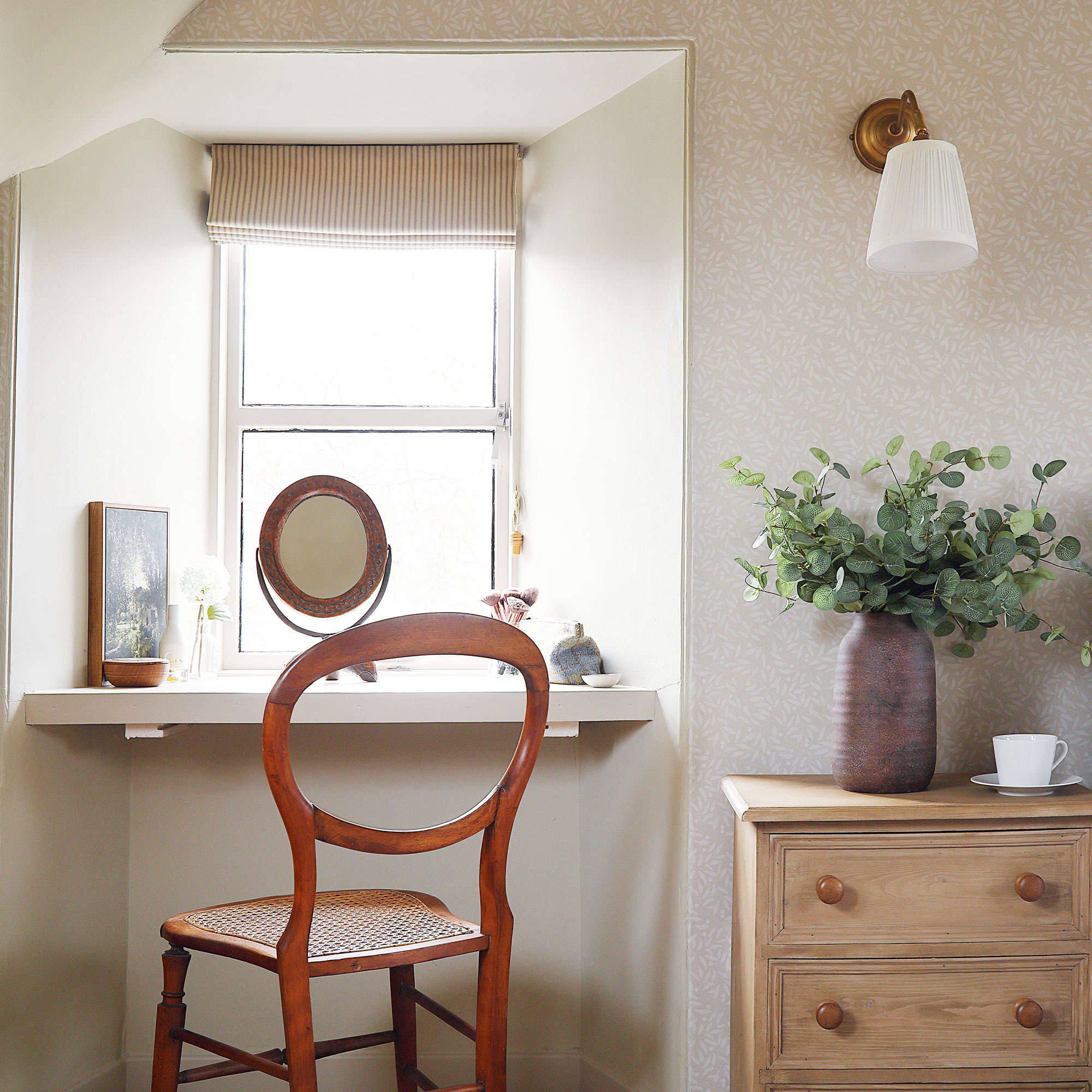 White bedroom with ledge for dressing table and pine chest of drawers