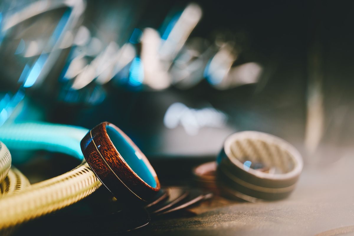 Some of Fender's new wedding rings, set against various Fender-themed backdrops