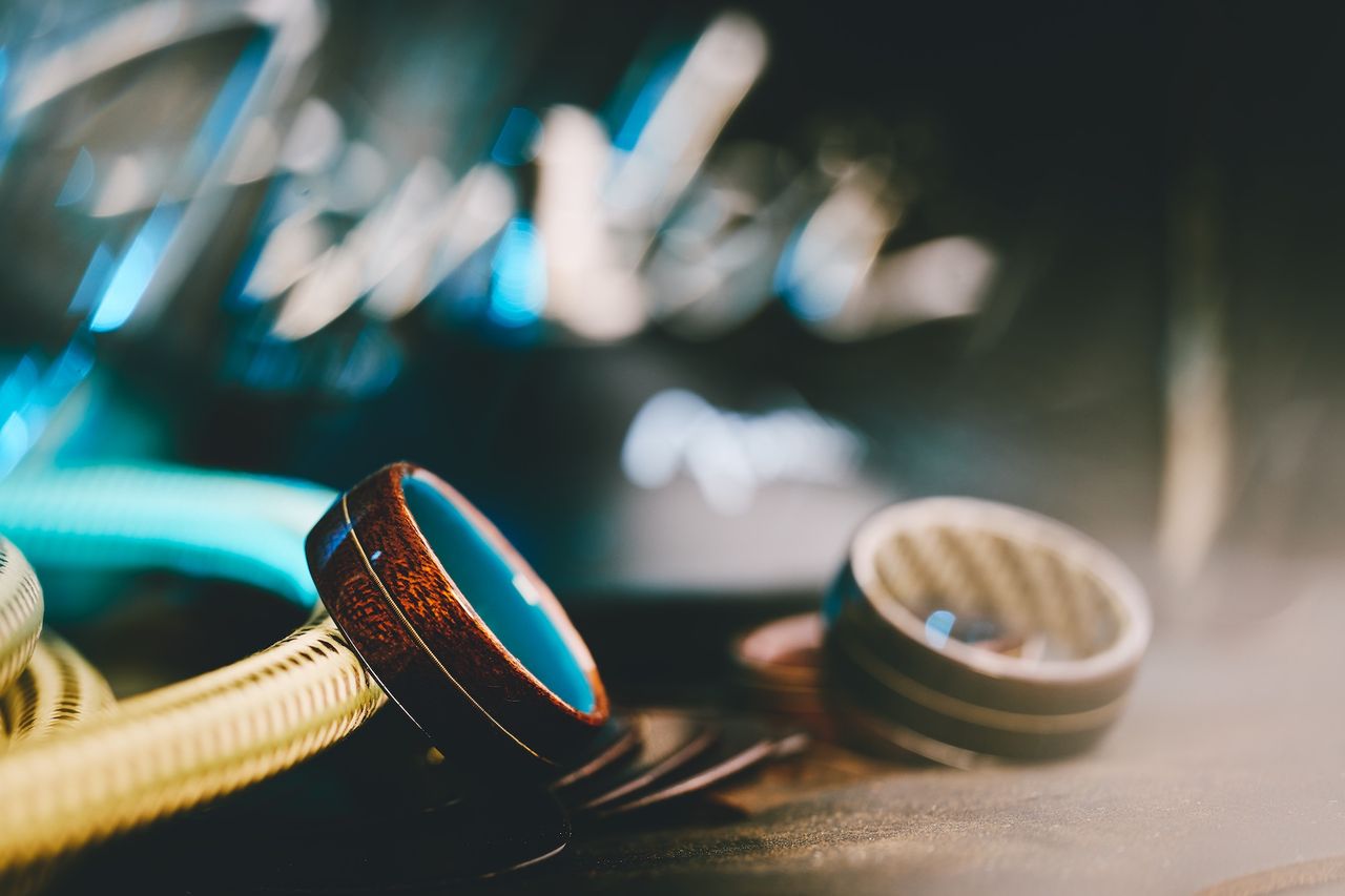 Some of Fender's new wedding rings, set against various Fender-themed backdrops