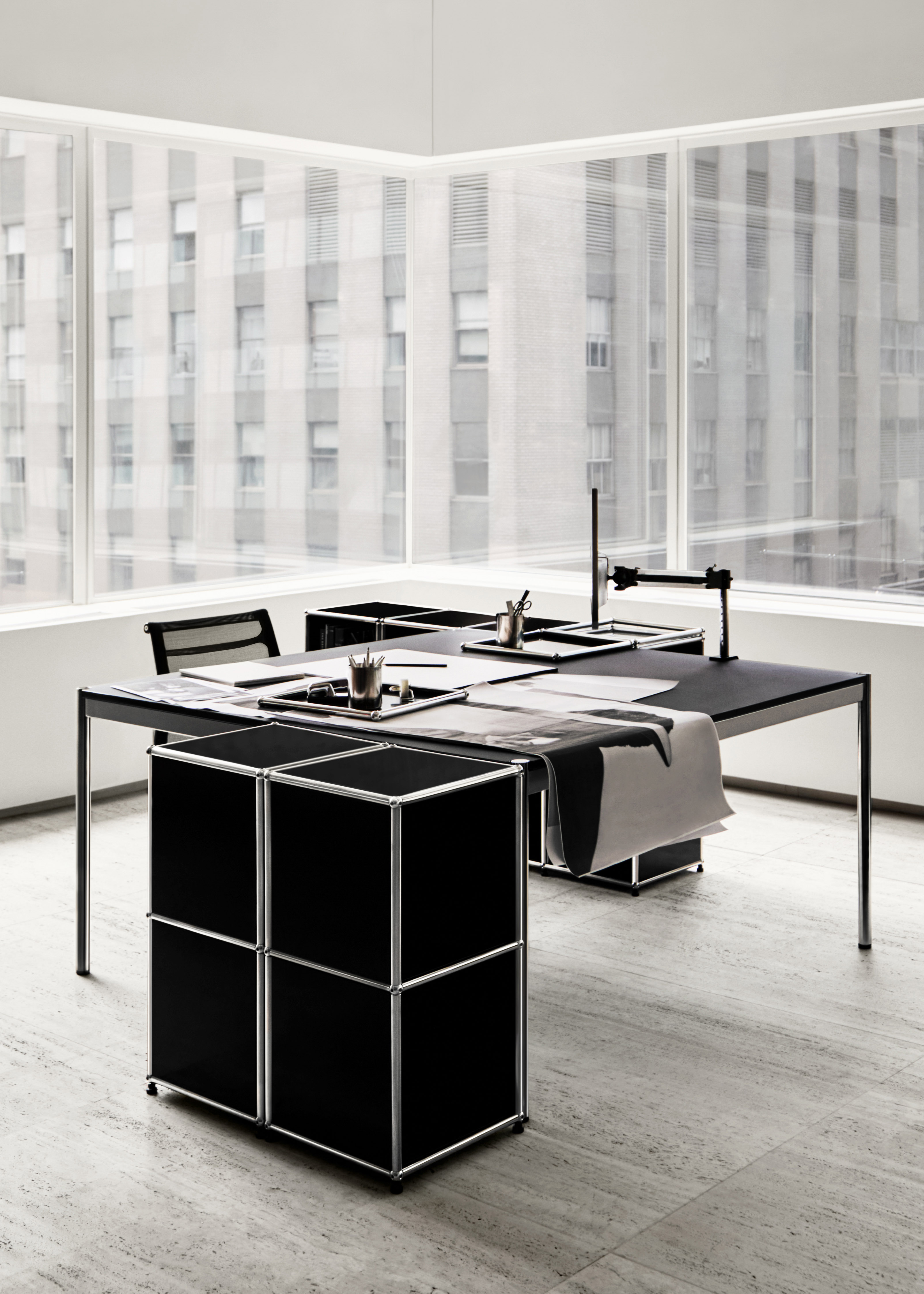 Black and white office space furnished with USM Haller system