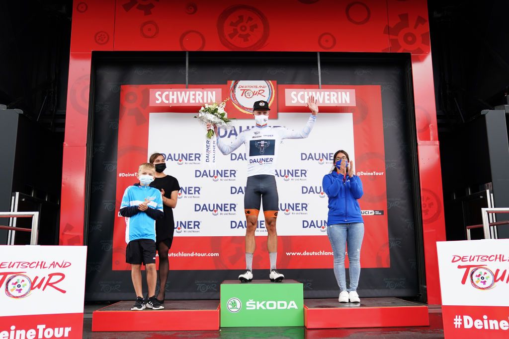 SCHWERIN GERMANY AUGUST 26 Jon Knolle of Germany and Team Sks Sauerland Nrw celebrates winning the White Best Young Rider Jersey on the podium ceremony after the 35th Deutschland Tour 2021 Stage 1 a 191km stage from Stralsund to Schwerin DeineTour on August 26 2021 in Schwerin Germany Photo by Christian KasparBartkeGetty Images