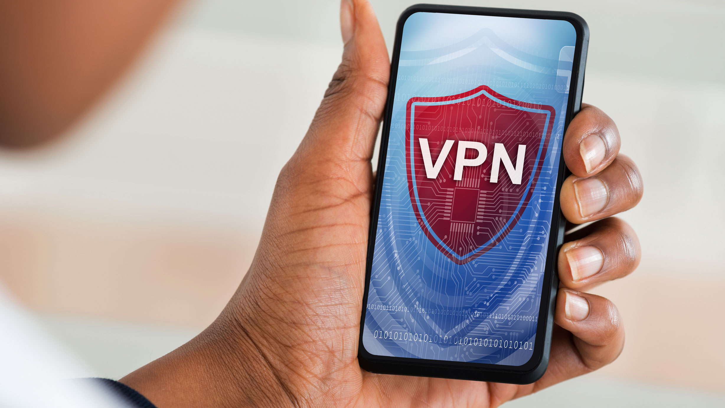 VPN on a phone screen held by a man