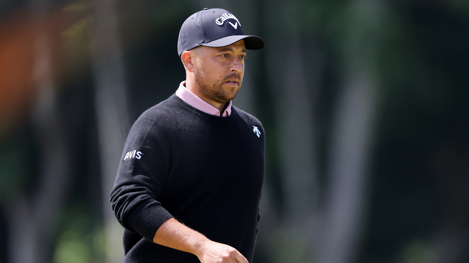 Xander Schauffele walks off the green