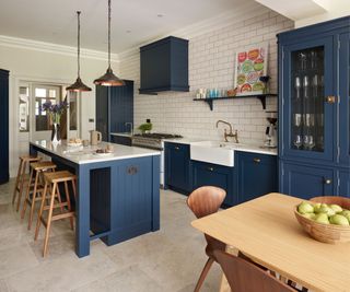 Dark blue and white kitchen with brass hardware