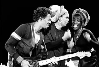 (from left) Junior Marvin, Marcia Griffiths and Rita Marley perform onstage with Bob Marley & the Wailers, July 21, 1978.