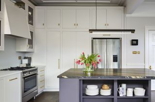 Kitchen with white cabinets and blue island
