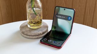 The Razr Ultra 2025 next to a small vase with a plant inside