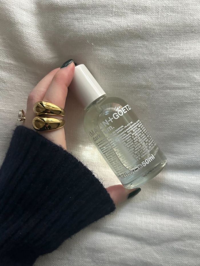 Junior beauty editor Grace Lindsay holding the Malin + Goetz Dark Rum perfume