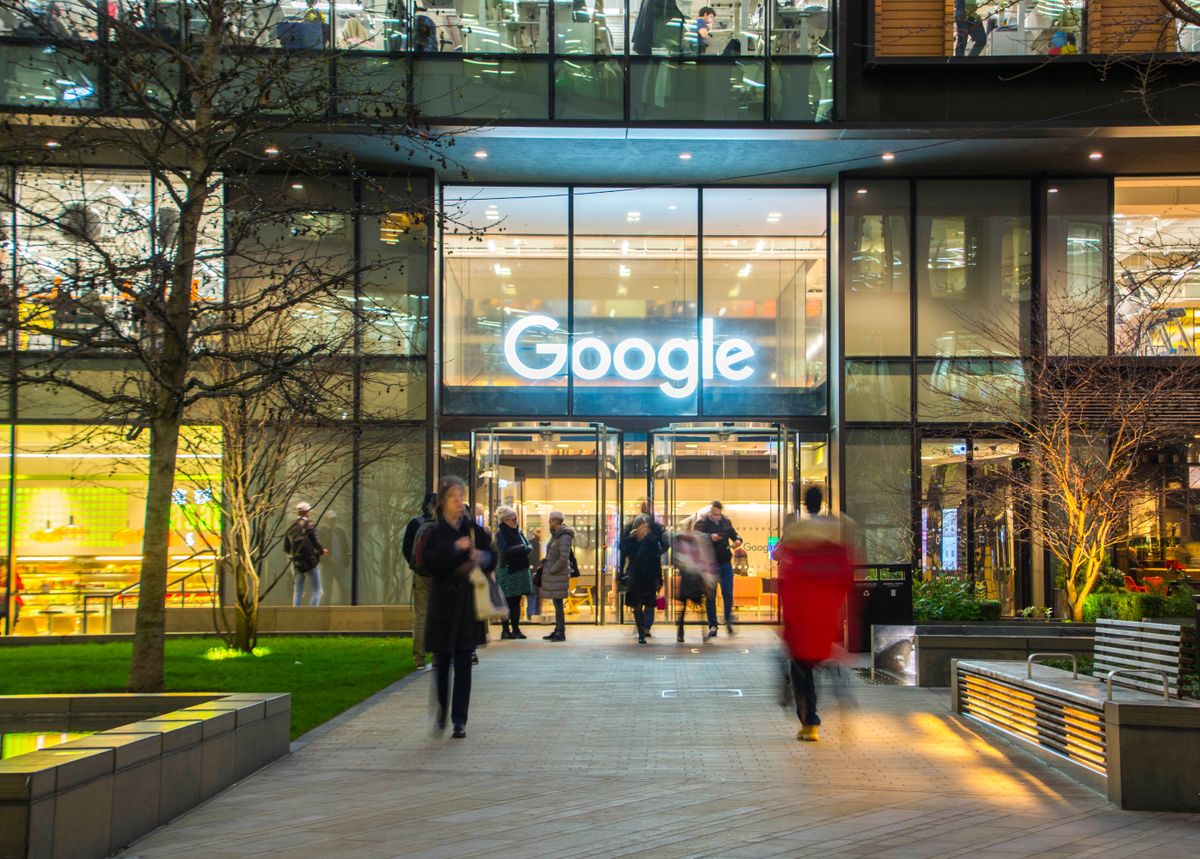 Google sign above a glass entrance to a building