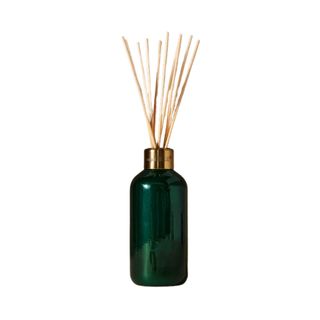 Capri Blue Fir & Firewood Reed Diffuser in a green bottle