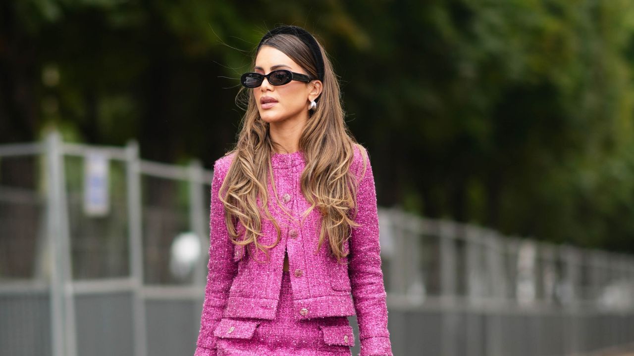 how to use the dyson airwrap - woman wearing two piece pink suit with black headband, sunglasses and beautiful curled blowdry - gettyimages getty images 1524384420