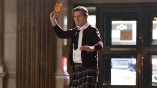 Liam Neeson as Frank Drebin throwing a lollipop in The Naked Gun