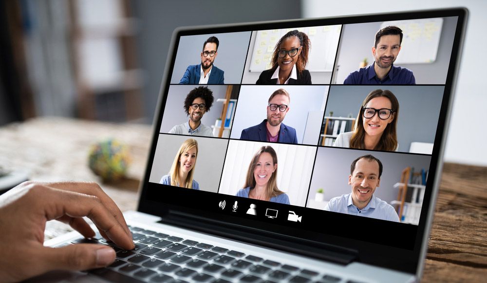 A video conference with nine participants on a laptop screen.