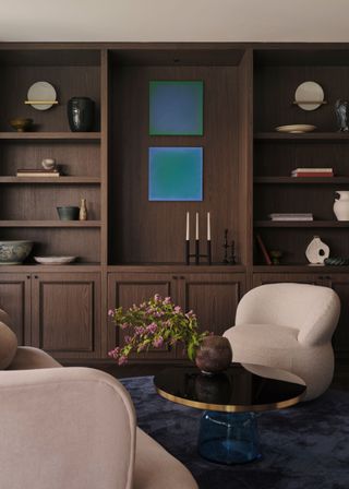 A living room with a large dark wood cabinetry