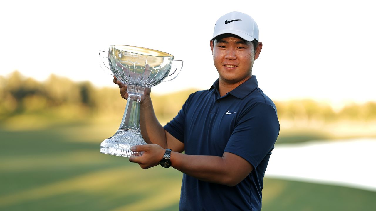 Tom Kim of South Korea poses with the trophy after putting in to win on the 18th green during the final round of the Shriners Children&#039;s Open at TPC Summerlin on October 15, 2023 in Las Vegas, Nevada.