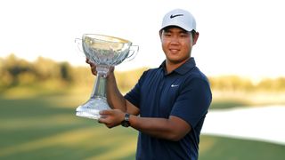Tom Kim of South Korea poses with the trophy after putting in to win on the 18th green during the final round of the Shriners Children's Open at TPC Summerlin on October 15, 2023 in Las Vegas, Nevada.