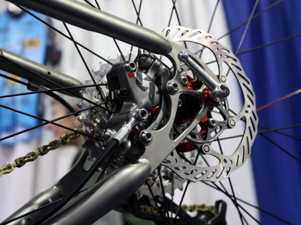 The rear brake caliper is neatly tucked away between the stays.
