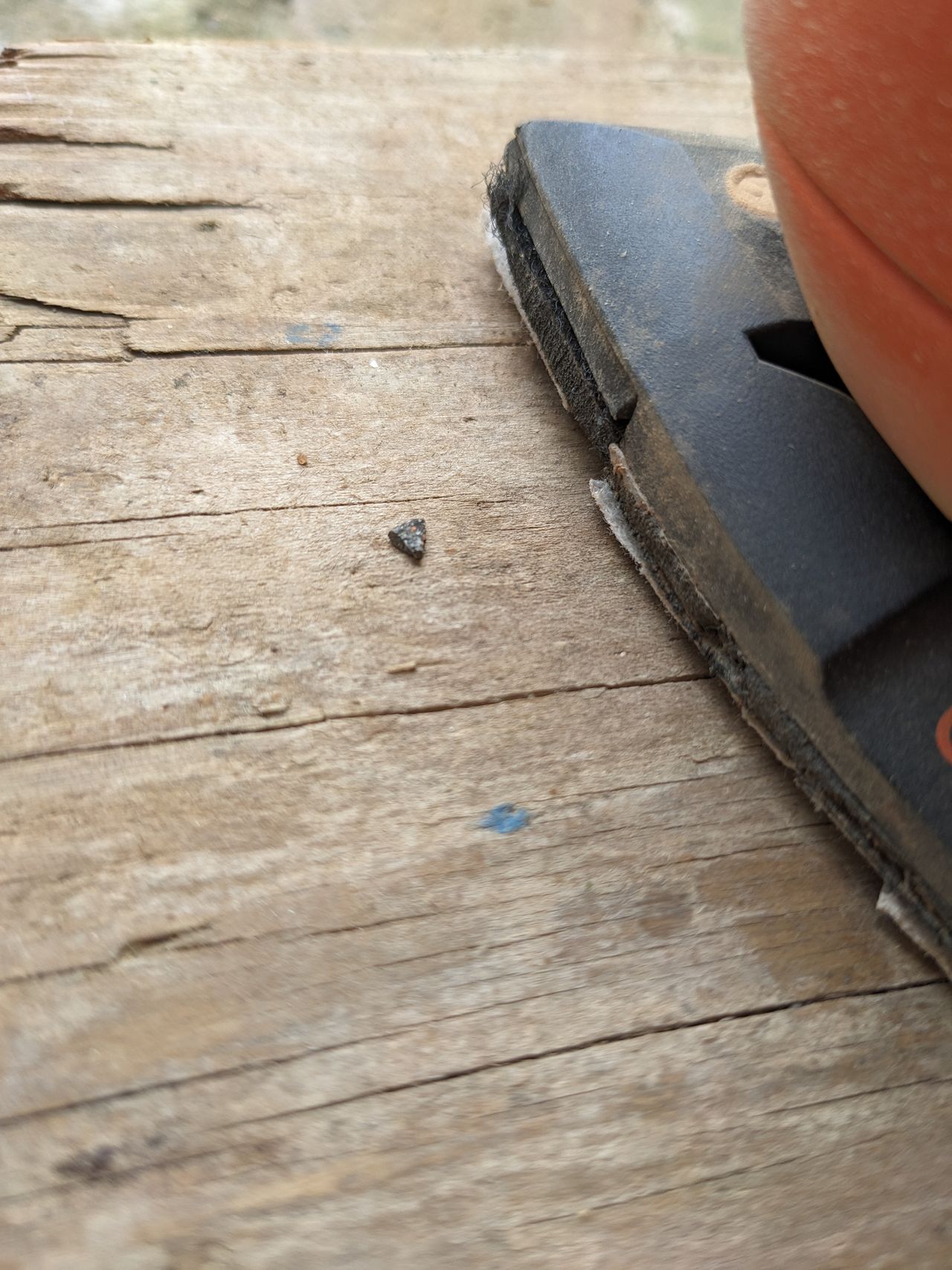 A wooden board being sanded
