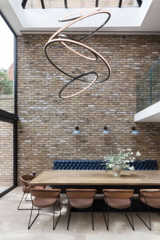 light extension with large pendant light above dining room