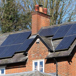 Solar panels on roof of red brick house