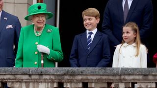 Queen Elizabeth II, Prince George of Cambridge and Princess Charlotte of Cambridge stand on the balcony of Buckingham Palace