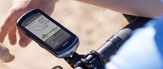 A Garmin Edge 1040 fitted to the handlebars of a bike, with a map summary on screen