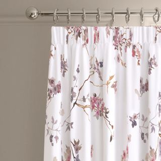 M&S Sateen Cherry Blossom Pencil Pleat Blackout Curtains hung on a silver curtain pole