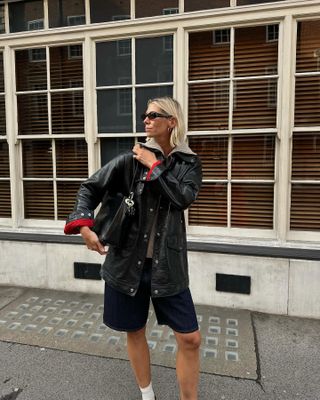 a woman in shorts and a jacket