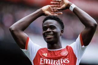 Bukayo Saka celebrates after scoring for Arsenal against Bournemouth in May 2024.