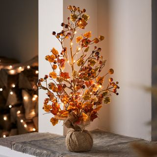 fall twig tree decoration on hearth