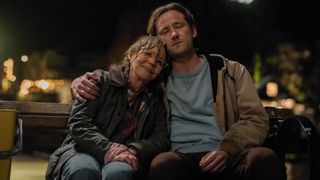 L-R: Tova (Sally Field) and Cameron (Lewis Pullman) sit together on a bench at night in a scene from Netflix's "Remarkably Bright Creatures"