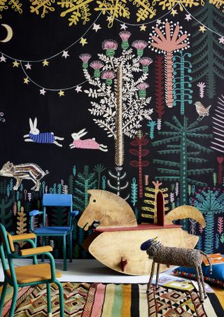 Playroom ideas with a coordinated and colorful blackboard paint, furniture including wooden rocking horse and patterned rug.
