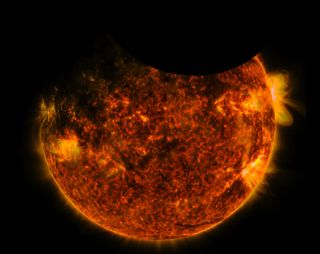 NASA's Solar Dynamics Observatory witnesses the moon and the Earth passing across the face of the sun simultaneously on Sept. 1, 2016.