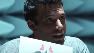 Ben Affleck flippantly holding an ink blot test card in Armageddon.