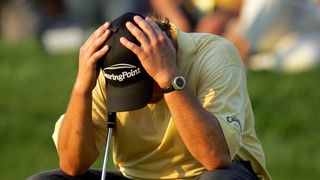 Phil Mickelson holds his head in his hands during the 2006 US Open