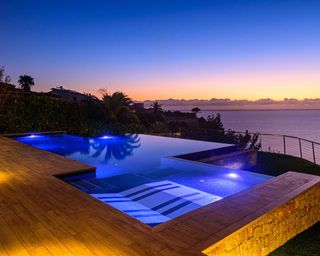 pool with view at night, designed by CONSTRUMA