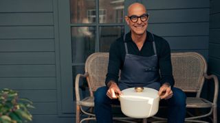 Stanley Tucci sitting outside with a pan