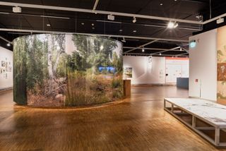 Round green installation at architecture exhibition, part of Oslo Architecture Triennale 2022