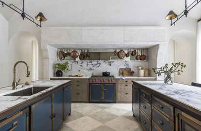 A kitchen with marble splashback that goes up the wall