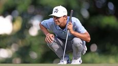 Miles Russell crouches down behind a putt during the 2024 Butterfield Bermuda Championship