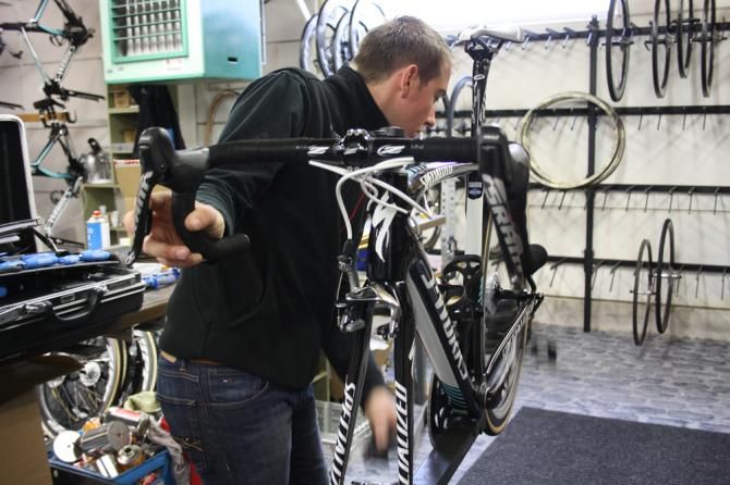 A team mechanic checks over one of the bikes from Gent-Wevelgem