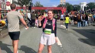 author posing with marathon finishers medal